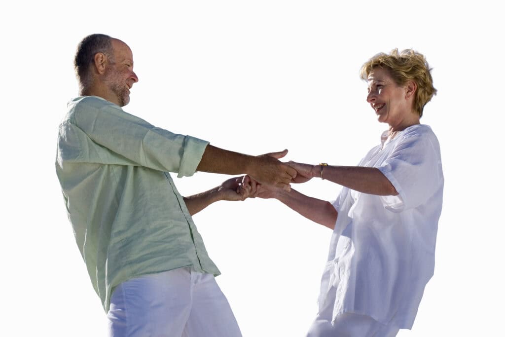 Dancers of different ages practicing a low-impact exercise ballroom workout.